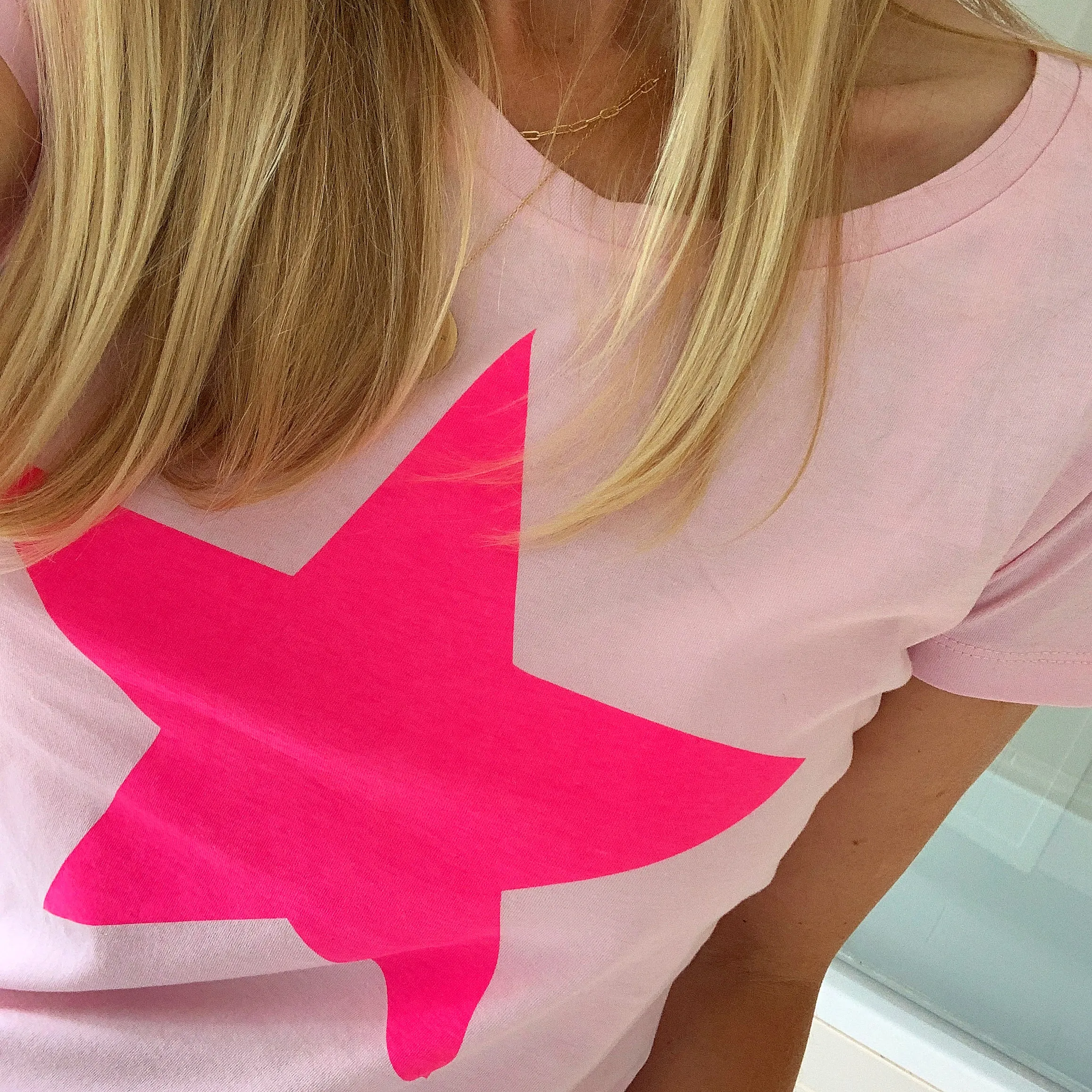 Neon pink star on pink tee