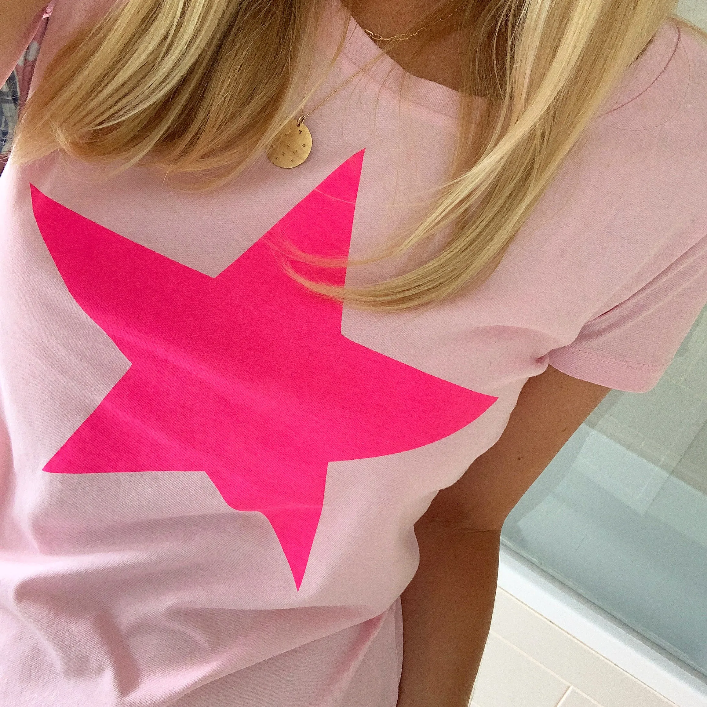 Neon pink star on pink tee